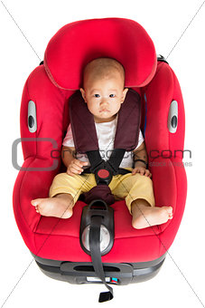 Baby boy sitting in car seat isolated