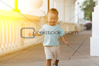 Asian baby boy running at outdoor