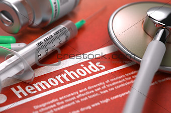Hemorrhoids - Printed Diagnosis on Orange Background.