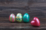 Easter eggs with red heart on wooden backgorund