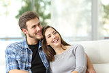 Couple at home thinking and looking sideways