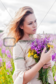 Attractive sad girl on meadow