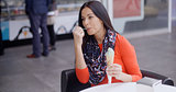 Woman eating an ice cream in a parlor or cafe