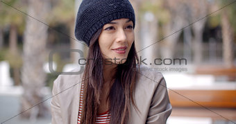 Cute smiling young woman in knitted hat