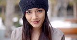 Pretty thoughtful young woman in a woolly cap