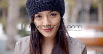 Pretty thoughtful young woman in a woolly cap