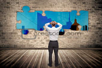 Composite image of businessman standing back to camera hands on head