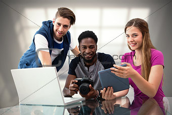 Composite image of creative young business team looking at digital tablet