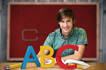 Composite image of student sitting in library reading