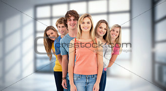 Composite image of full length shot of a smiling group standing behind one another at various angles