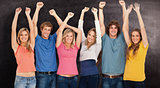 Composite image of a group of people with their hands raised