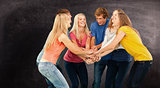 Composite image of group of friends about to cheer with their hands stacked