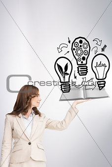 Composite image of businesswoman showing a book