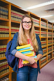 Composite image of pretty student in the library