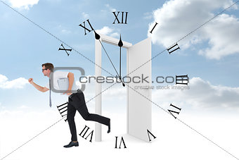 Composite image of geeky businessman running late