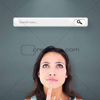 Composite image of pretty brunette looking up thoughfully