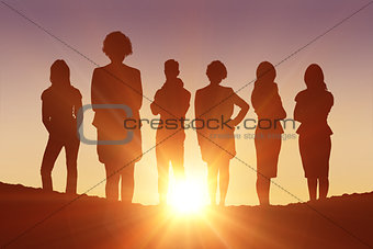 Composite image of standing silhouettes