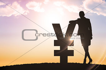 Composite image of silhouette beside yen symbol