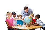 Composite image of cute pupils and teacher looking at globe in library