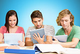 Composite image of college students using digital tablets in library