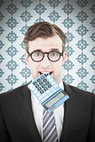 Composite image of geeky businessman biting calculator