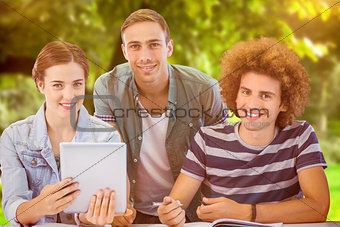 Composite image of fashion students using tablet