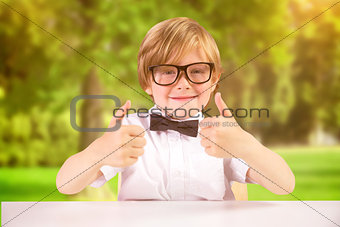 Composite image of cute pupil showing thumbs up