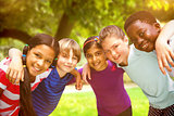 Composite image of happy children forming huddle at park