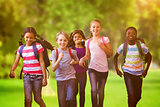 Composite image of school kids running in school corridor