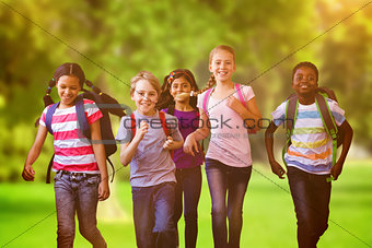 Composite image of school kids running in school corridor