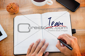 Team against man writing notes on diary