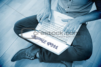 Web traffic against young creative businessman working on laptop