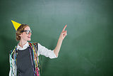 Composite image of happy geeky hipster pointing something