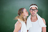 Composite image of geeky hipster kissing her boyfriend