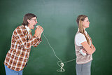 Composite image of geeky hipsters using string phone