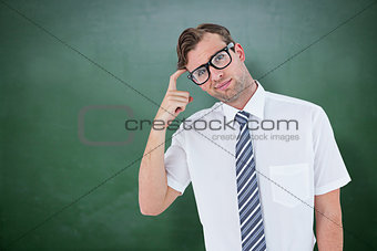 Composite image of geeky businessman thinking with finger on temple