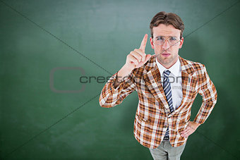 Composite image of upset geeky hipster pointing at camera