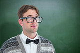 Composite image of thoughtful geeky hipster