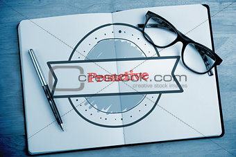 Proactive against overhead of open notebook with pen and glasses