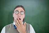 Composite image of geeky hipster looking surprised at camera