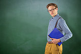 Composite image of geeky student holding a notebook