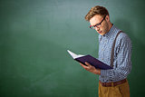 Composite image of geeky student reading a book