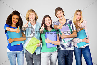 Composite image of happy college students gesturing thumbs up