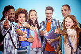 Composite image of smiling group of students doing thumbs up