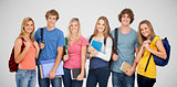 Composite image of smiling students wearing backpacks and holding books in their hands