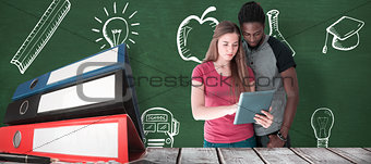 Composite image of creative team looking at digital tablet