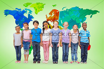 Composite image of cute pupils smiling at camera in classroom