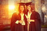 Composite image of two women embracing each other after they graduated from university