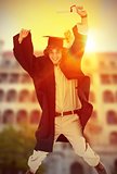 Composite image of male student in graduate robe jumping