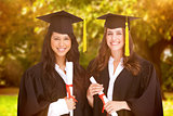 Composite image of two friends stand together after graduating